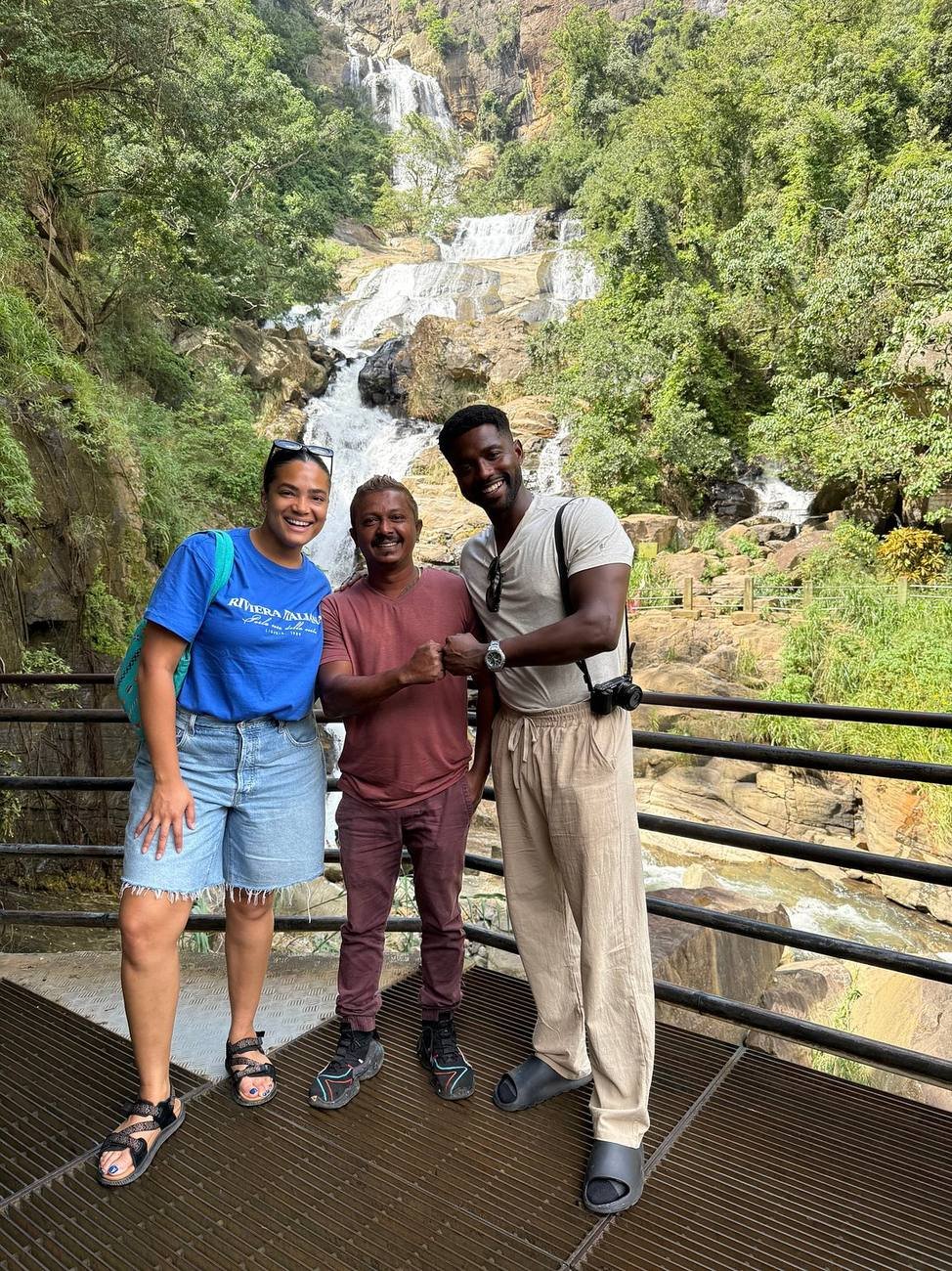 Danushka with two travellers at a Sri Lankan waterfall during a private tour