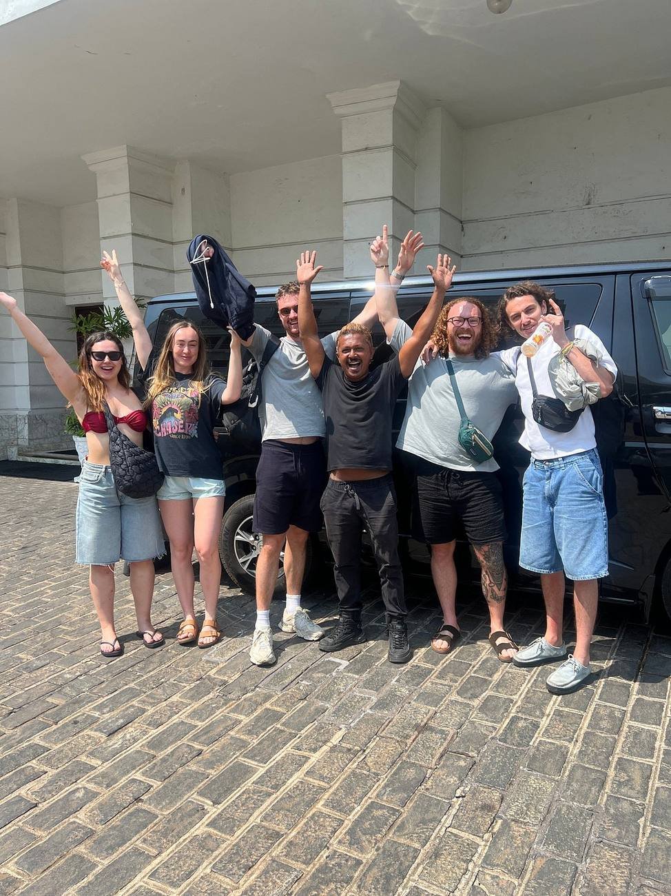 A group of travellers celebrating at the start of their 22-day private tour with KIYON